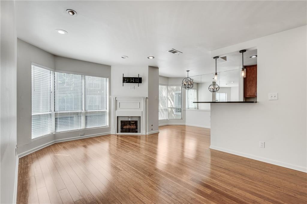 244 13th Street Northeast, Unit 118 Atlanta, GA 30309 - Photo 19 of 48 a view of empty room with wooden floor and fireplace