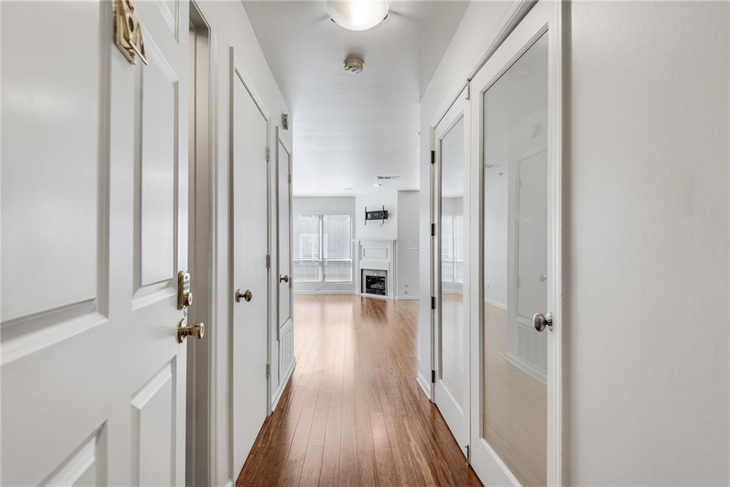 244 13th Street Northeast, Unit 118 Atlanta, GA 30309 - Photo 2 of 48 a view of a hallway with a wooden floor