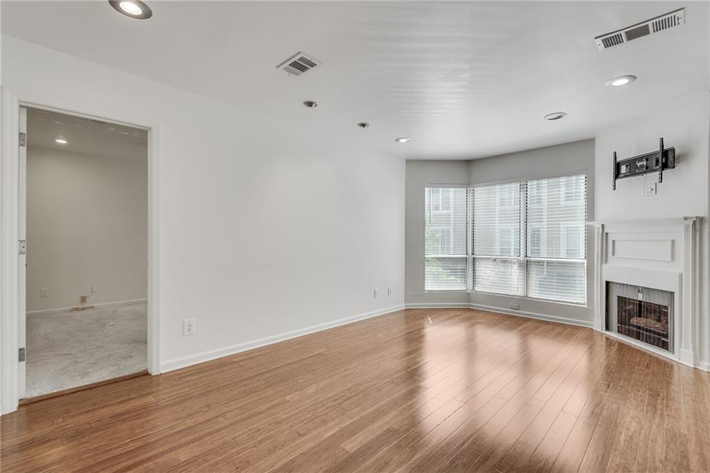 244 13th Street Northeast, Unit 118 Atlanta, GA 30309 - Photo 21 of 48 wooden floor in an empty room with a window
