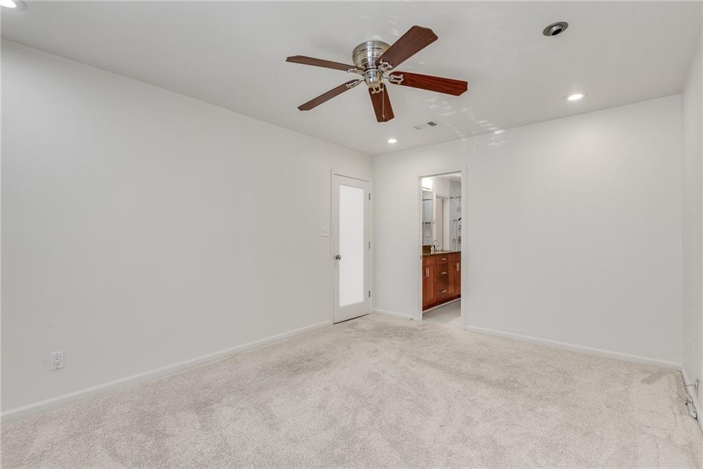 244 13th Street Northeast, Unit 118 Atlanta, GA 30309 - Photo 24 of 48 en empty room with ceiling fan and windows