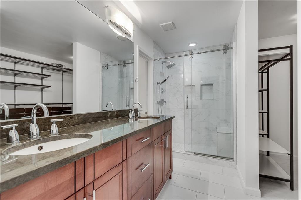 244 13th Street Northeast, Unit 118 Atlanta, GA 30309 - Photo 25 of 48 a bathroom with a granite countertop sink mirror and double