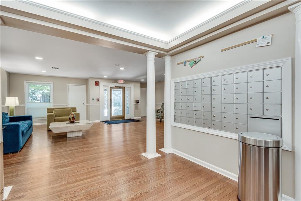 244 13th Street Northeast, Unit 118 Atlanta, GA 30309 - Photo 33 of 48 a view of a living room and dining room with wooden floor