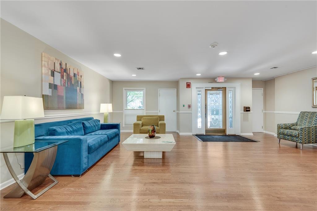 244 13th Street Northeast, Unit 118 Atlanta, GA 30309 - Photo 34 of 48 a living room with furniture and wooden floor