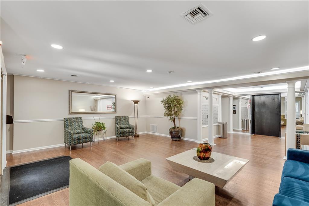 244 13th Street Northeast, Unit 118 Atlanta, GA 30309 - Photo 35 of 48 a living room with furniture and wooden floor