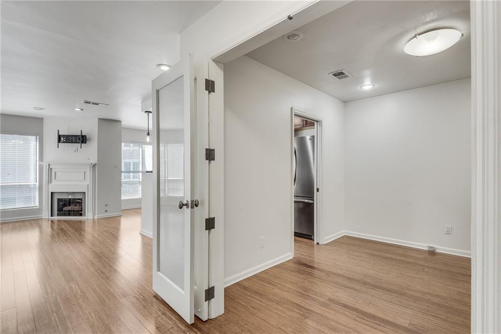244 13th Street Northeast, Unit 118 Atlanta, GA 30309 - Photo 5 of 48 a view of a hallway with wooden floor and staircase