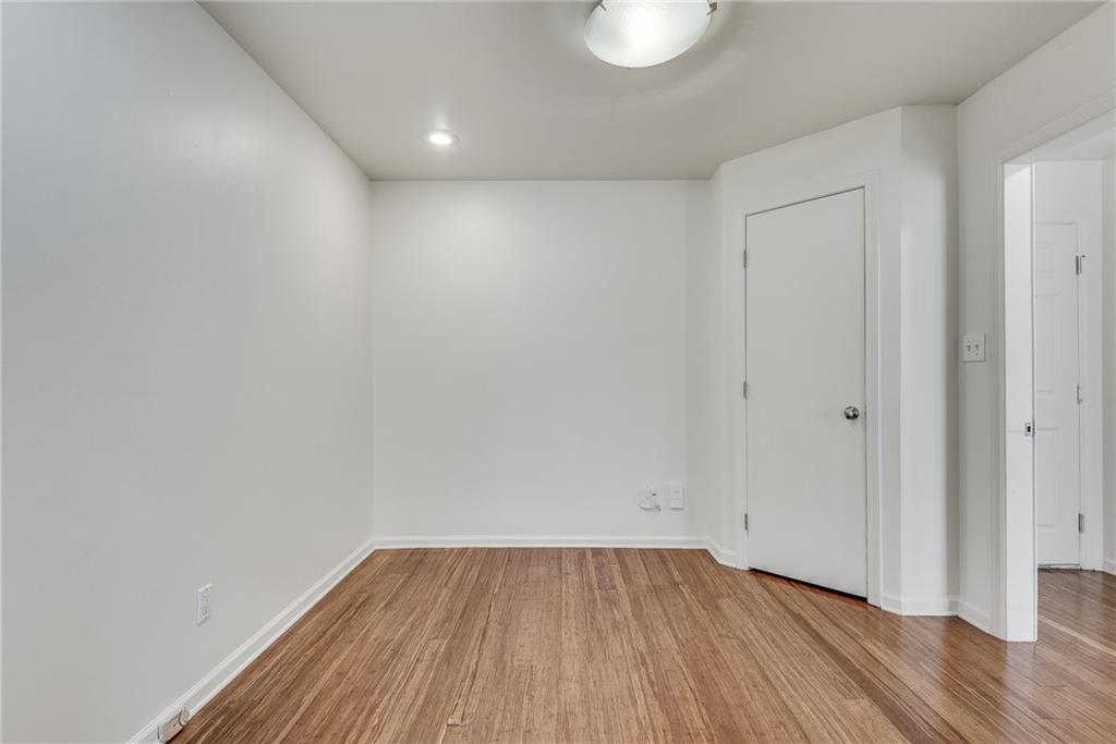 244 13th Street Northeast, Unit 118 Atlanta, GA 30309 - Photo 7 of 48 a view of an empty room with wooden floor and a window