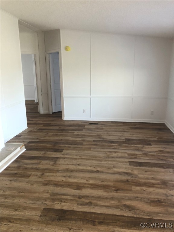 5523 Ridge Road Heathsville, VA 22473 - Photo 6 of 23 Empty room with a textured ceiling and dark hardwo
