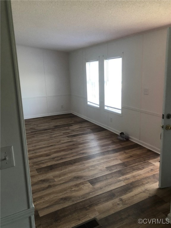 5523 Ridge Road Heathsville, VA 22473 - Photo 7 of 23 Spare room featuring a textured ceiling and dark w