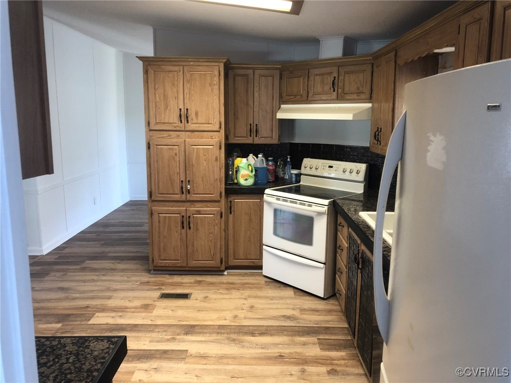 5523 Ridge Road Heathsville, VA 22473 - Photo 9 of 23 Kitchen with white appliances and light hardwood /
