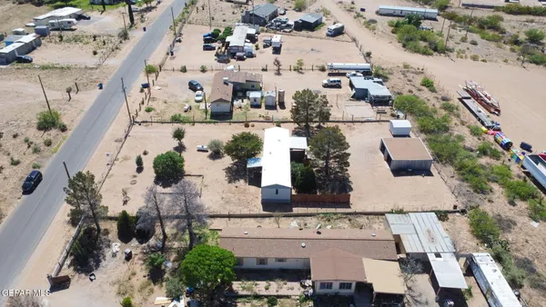 aerial view of a house with a fountain and large trees