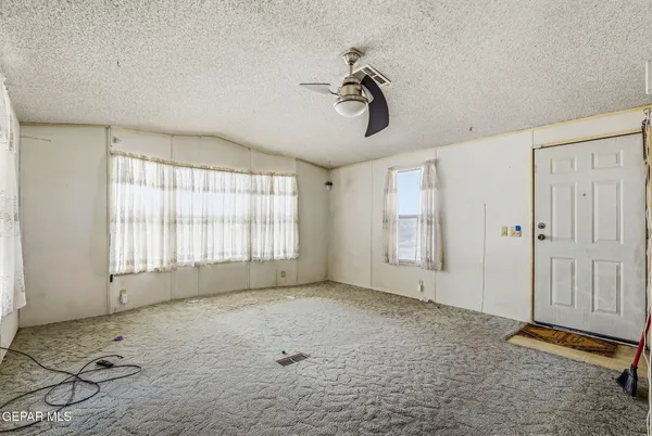 a view of a livingroom with a window and stairs