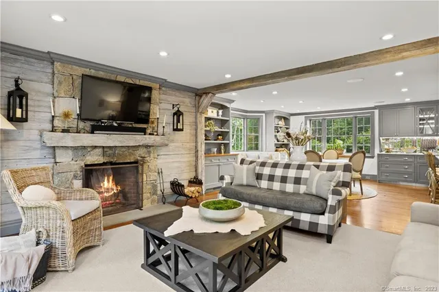 a living room with furniture a flat screen tv and a fireplace