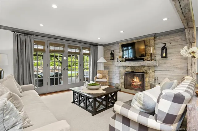 a living room with furniture fireplace and flat screen tv