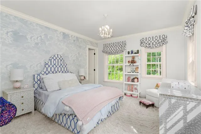 a spacious bedroom with a bed and a couch