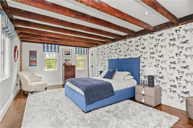 a spacious bedroom with a bed and a couch