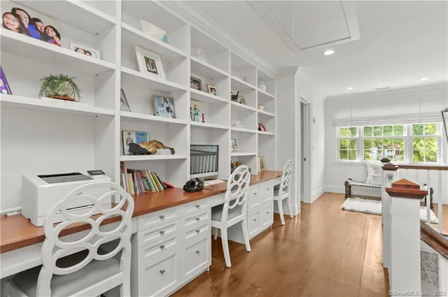 a bedroom with furniture and a book shelf