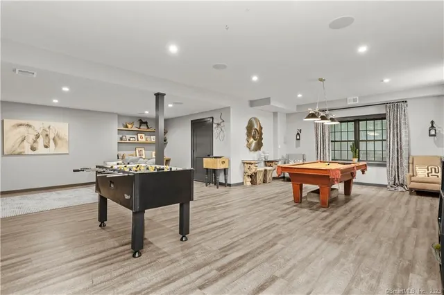 a living room with furniture a table and wooden floor
