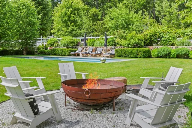 a view of yard with swimming pool and green space