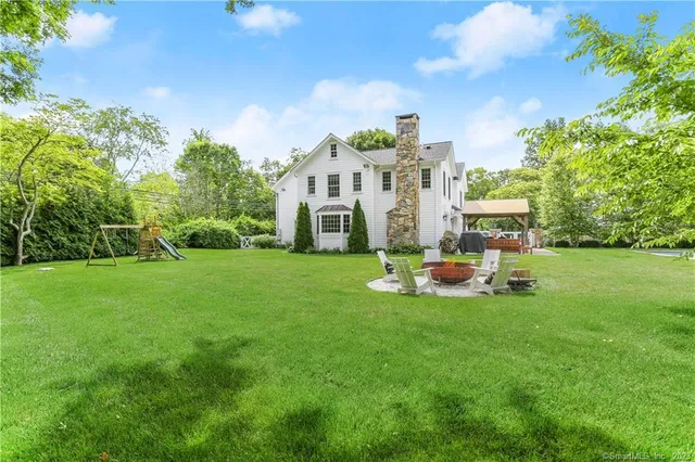 a view of a house with backyard sitting area and garden