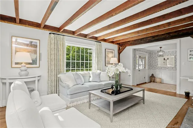 a living room with furniture and floor to ceiling windows