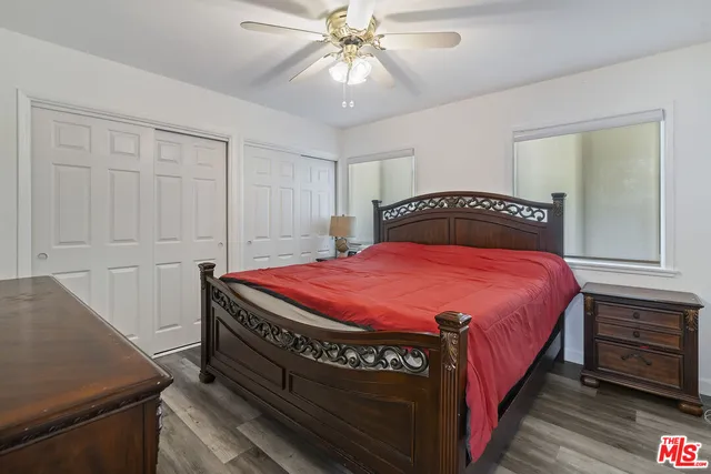 a spacious bedroom with a bed and a dresser