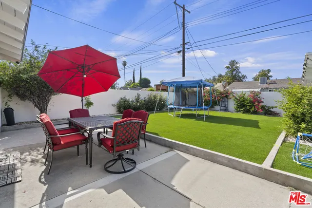 a view of a chairs and table in patio with a fire pit