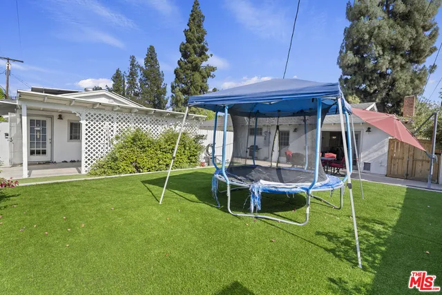 a view of a house with backyard and porch