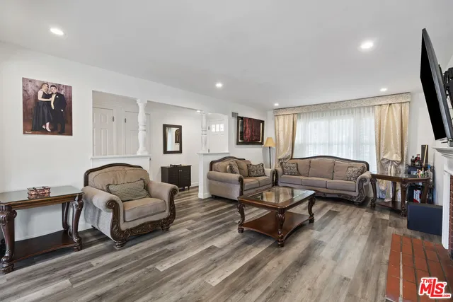 a living room with furniture or couch and a wooden floor