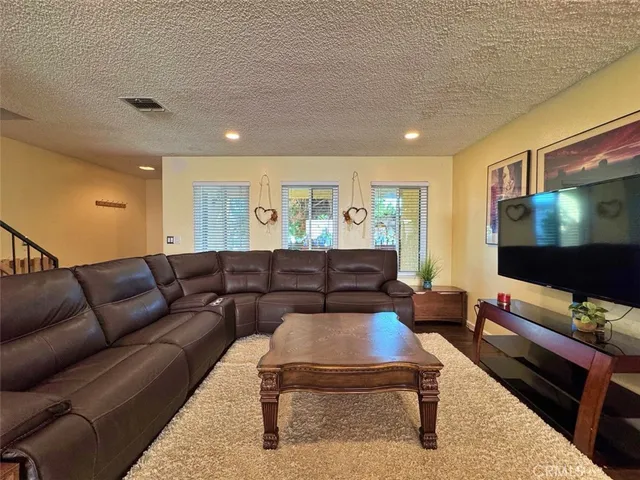 a view of a livingroom with furniture and stairs