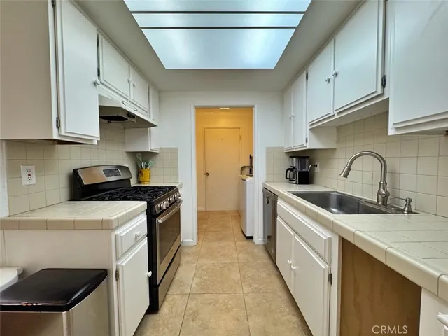 a stove top oven sitting inside of a kitchen