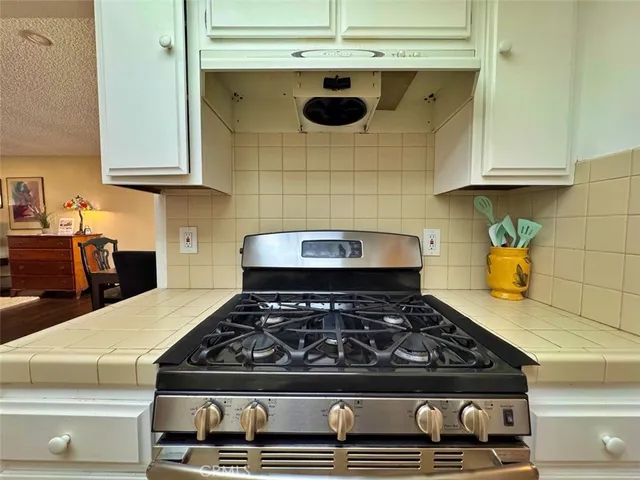 a kitchen with cabinets and appliances