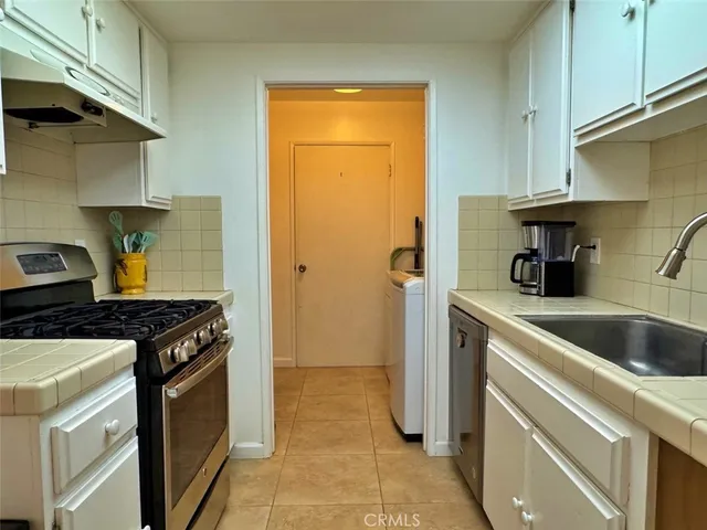 a kitchen with white cabinets and a sink