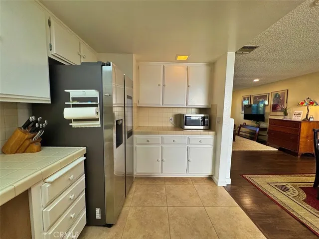 a view of a dining room with furniture a chandelier and wooden floor