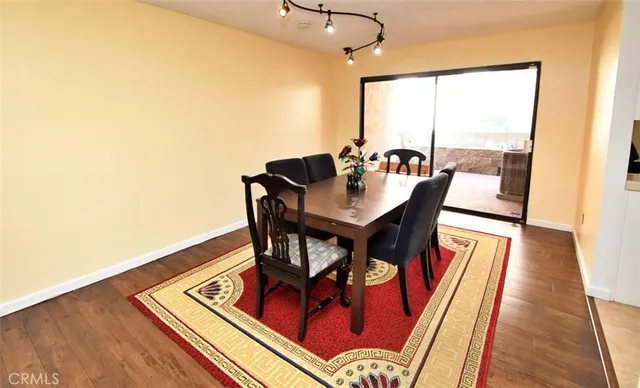 a view of a dining room with furniture a couch and wooden floor