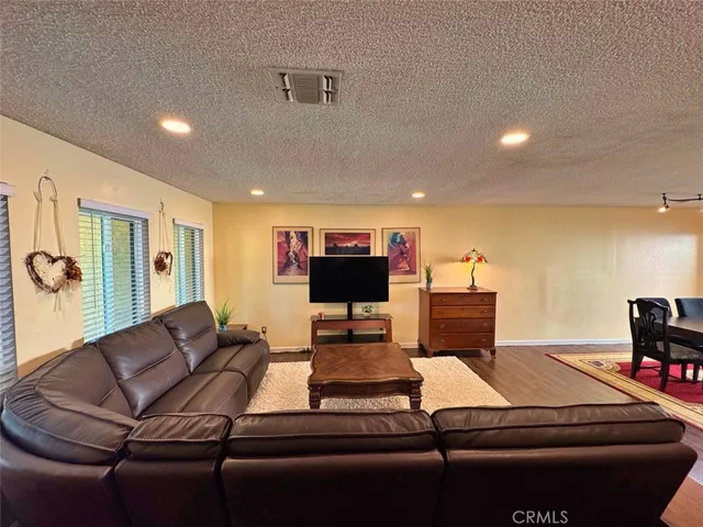 a bedroom with a bed and painting on the wall