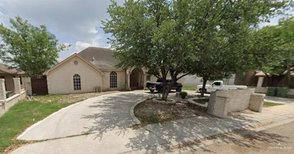 a view of backyard of house with outdoor seating and barbeque oven