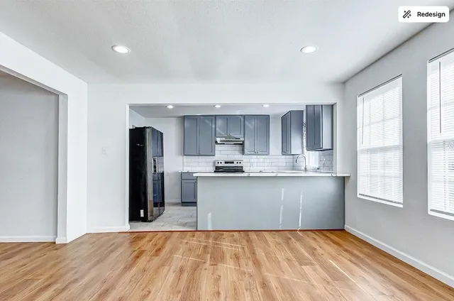 a kitchen with stainless steel appliances granite countertop a refrigerator and a sink