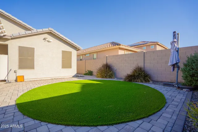 a front view of a house with a yard patio and swimming pool