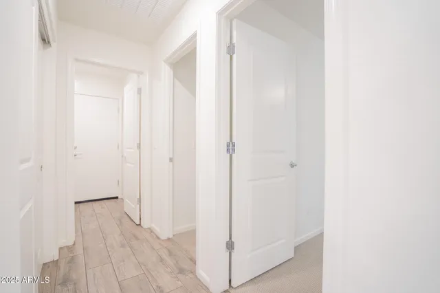 a view of a hallway with wooden floor