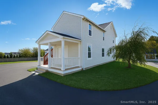 a view of a house with backyard porch and sitting area