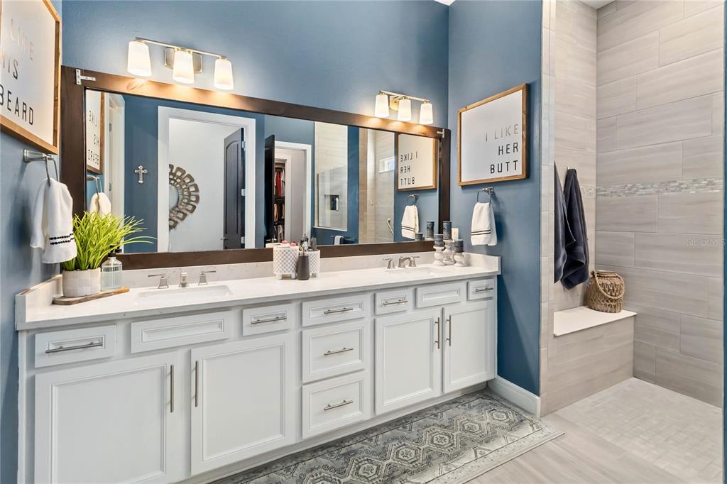 2744 Nature Vw Road St. Cloud, FL 34771 - Photo 13 of 49 a bathroom with a double vanity sink mirror and bathtub