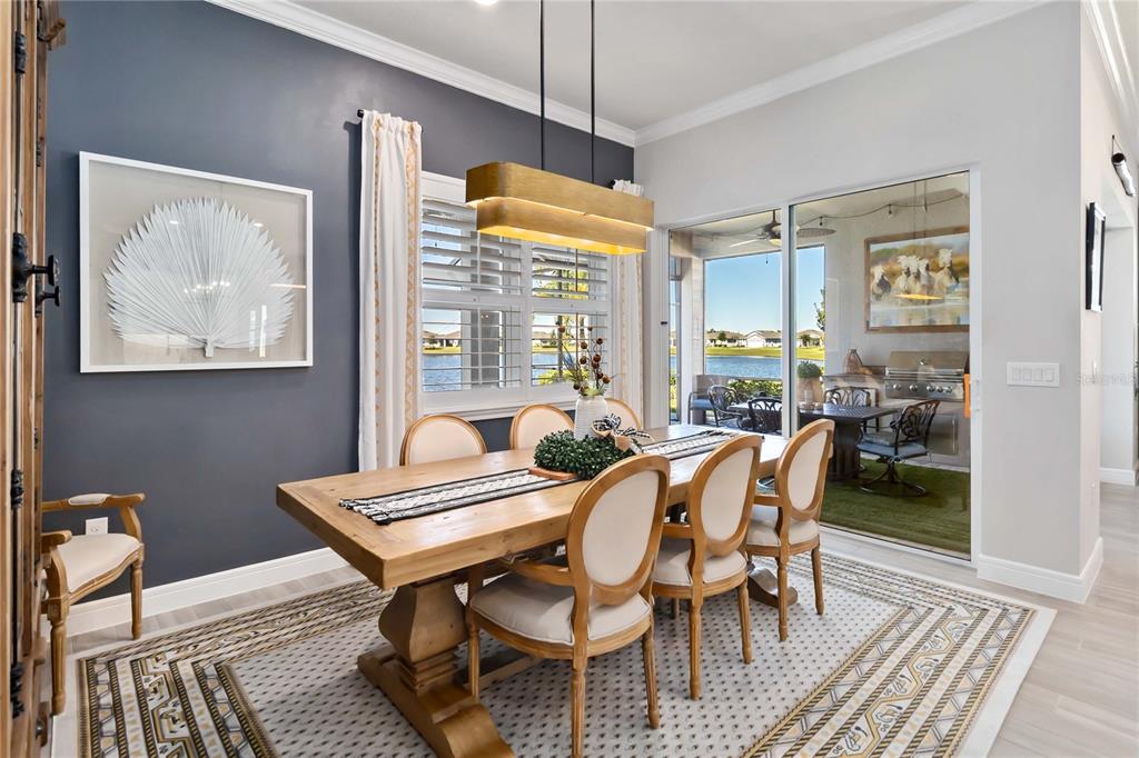 2744 Nature Vw Road St. Cloud, FL 34771 - Photo 19 of 49 a dining room with furniture a rug and wooden floor