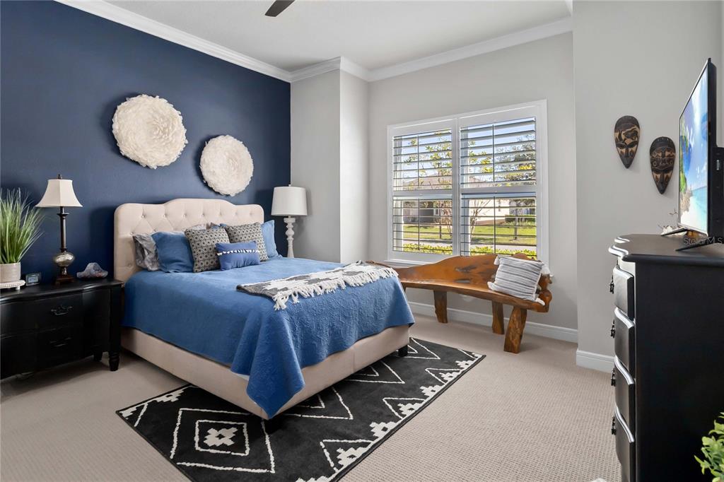 2744 Nature Vw Road St. Cloud, FL 34771 - Photo 27 of 49 a bedroom with a bed and dresser with mirror