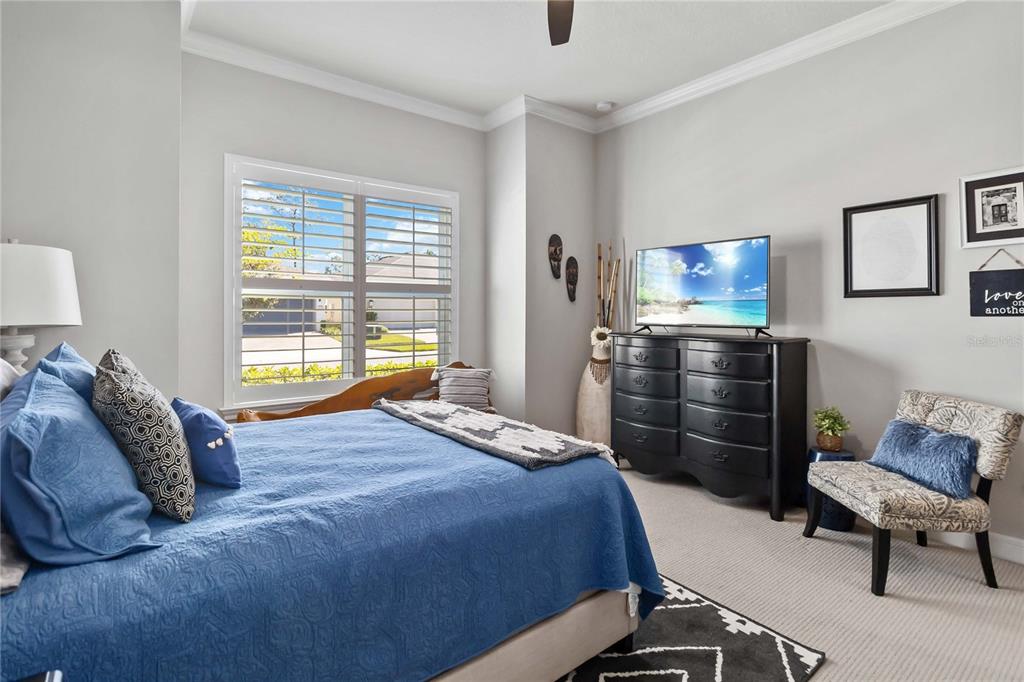2744 Nature Vw Road St. Cloud, FL 34771 - Photo 28 of 49 a bedroom with a bed a chair and potted plant on the dresser