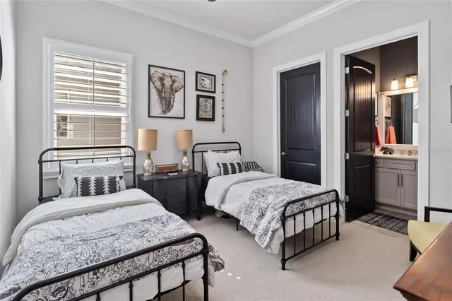 a bedroom with two beds and painting on the wall