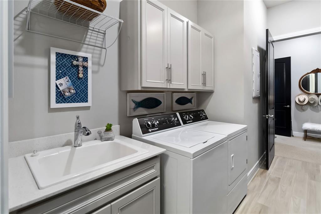 2744 Nature Vw Road St. Cloud, FL 34771 - Photo 34 of 49 a bathroom with a sink and a refrigerator