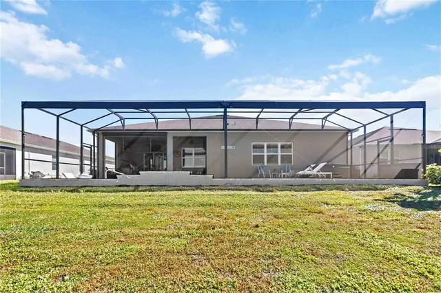 a view of a house with swimming pool and a yard