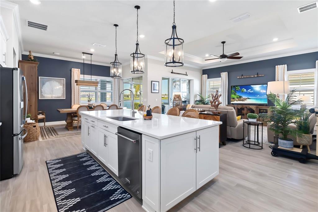 2744 Nature Vw Road St. Cloud, FL 34771 - Photo 6 of 49 a kitchen with a sink stainless steel appliances and living room view