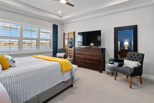 a spacious bedroom with a bed and large windows