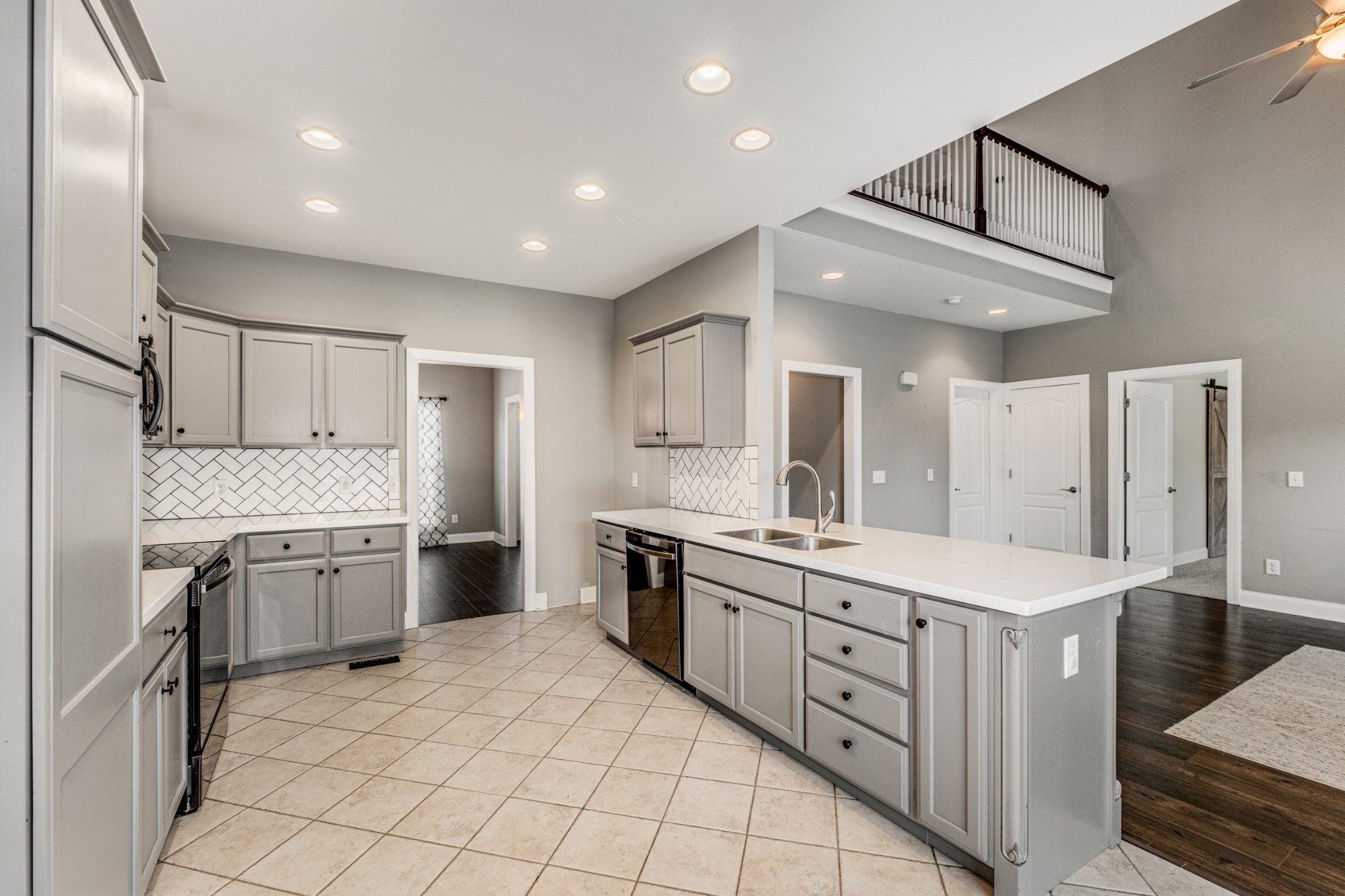 331 Midtown Trail Mount Juliet, TN 37122 - Photo 11 of 30 a kitchen with granite countertop a sink stove a refrigerator and white cabinets